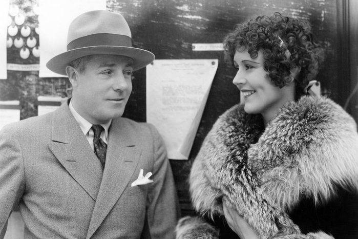 Woman in a fur coat having a conversation with a man