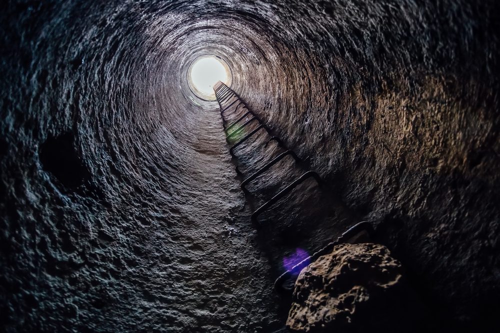 View from inside vertical tube downcast shaft with ladder 