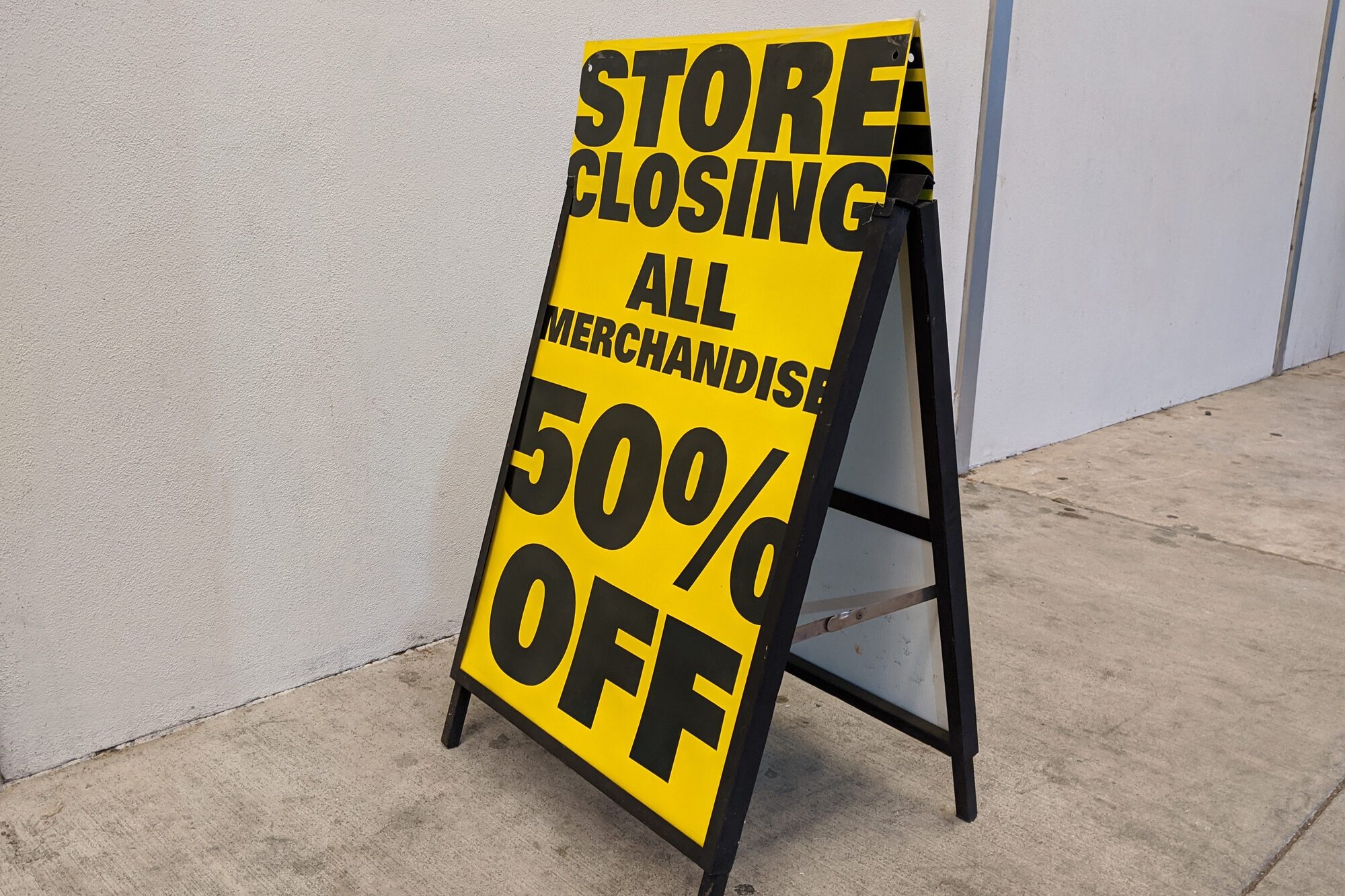 Store Closing 50% Off sign outside of a liquidated business