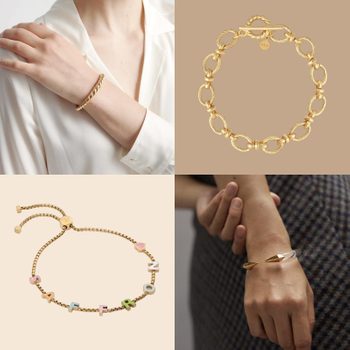 Four gold bracelets displayed; two worn on wrists, two standalone. One includes colorful letters and symbols on a cream backdrop.