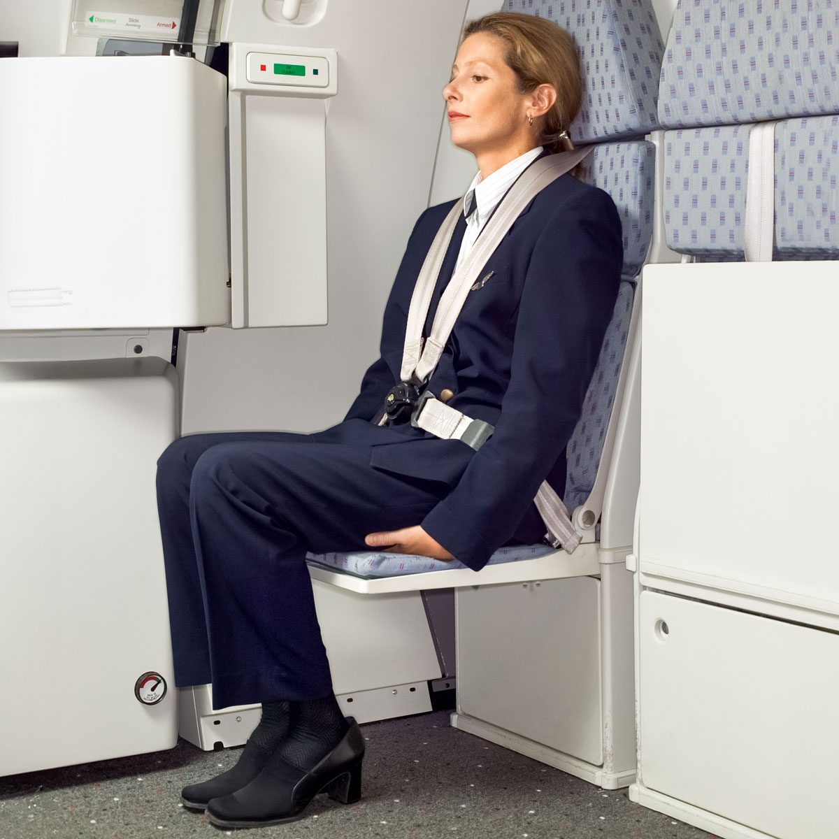Here’s Why Flight Attendants Might Sit on Their Hands During Takeoff and Landing