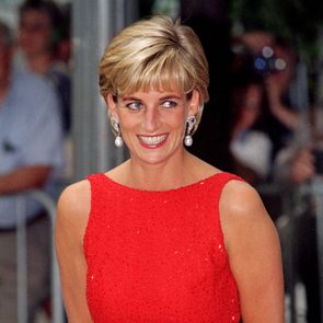 Princess Diana wears a red sleeveless dress