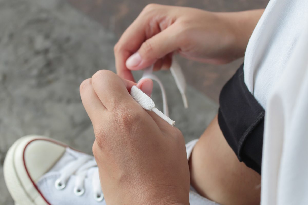 close up of hands tying shoelaces
