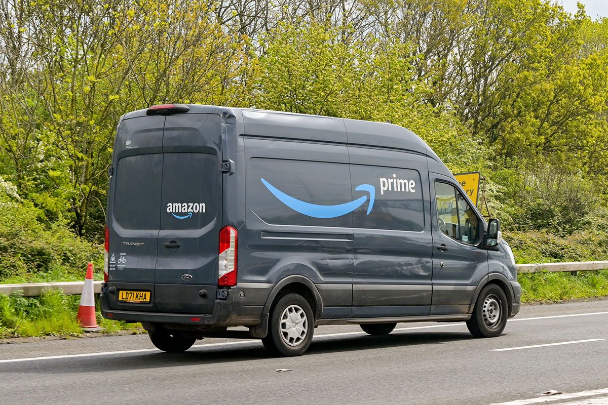 Delivery van used by Amazon Prime driving on a road on the outskirts of Bristol