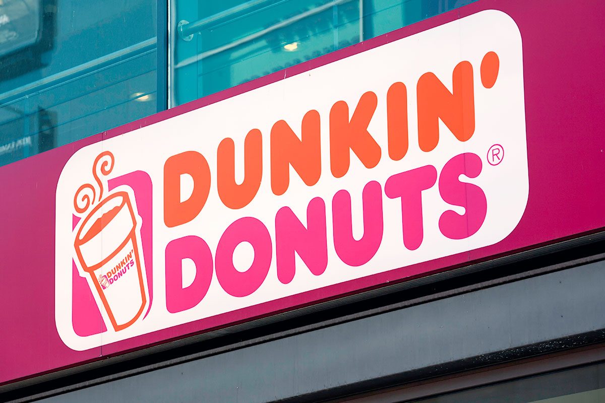 Dunkin Donuts logo sign at the entrance to one of their stores.