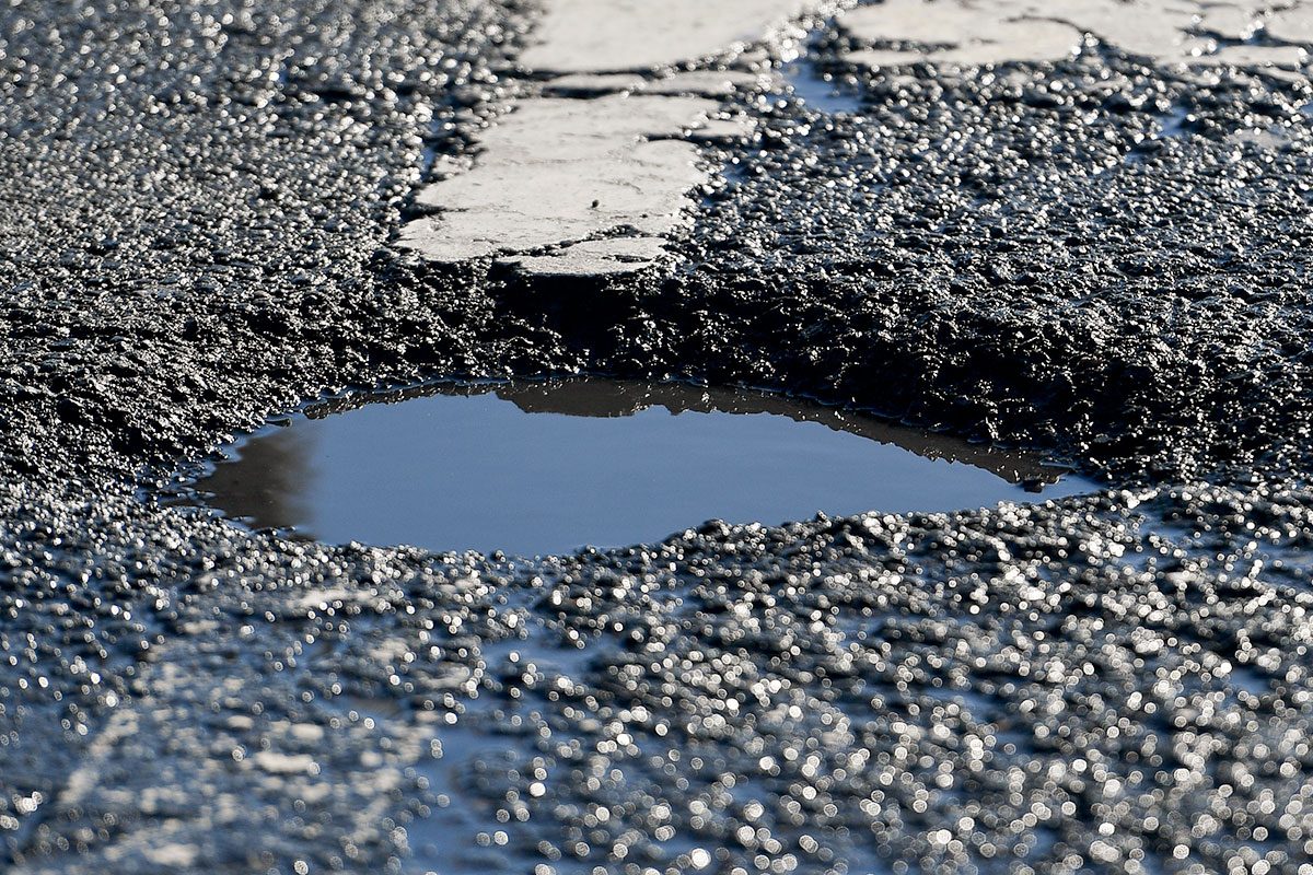 A pothole in the street on Reading Ave at the intersection
