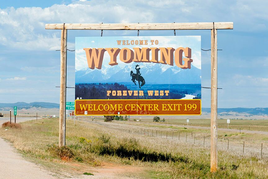 Welcome sign on a highway, Welcome to Wyoming, Forever West, flat landscape, Wyoming, USA 