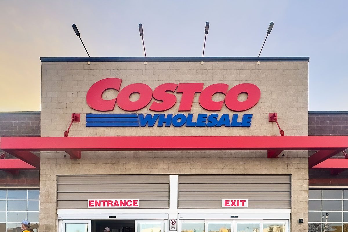 Exterior shot of a Costco Wholesale store at dusk with Costco Wholesale signage