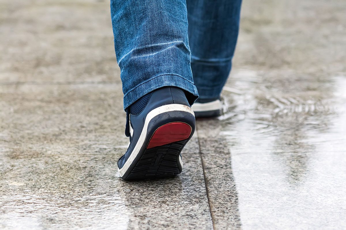 A man walks through a puddle